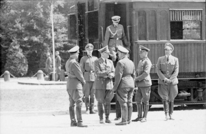 Adolf Hitler and his staff in front of the armistice wagon in Compiegne, France. The wagon was taken out of the near museum and placed at the exact same location as in 1918